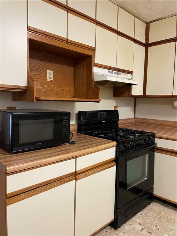 350 Peyton Place Southwest Atlanta, GA 30311 - Photo 2 of 14 a kitchen with stainless steel appliances granite countertop a stove microwave and cabinets