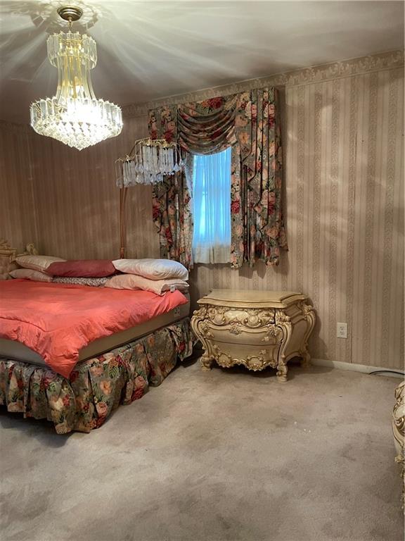 350 Peyton Place Southwest Atlanta, GA 30311 - Photo 10 of 14 a bedroom with a bed and a chandelier