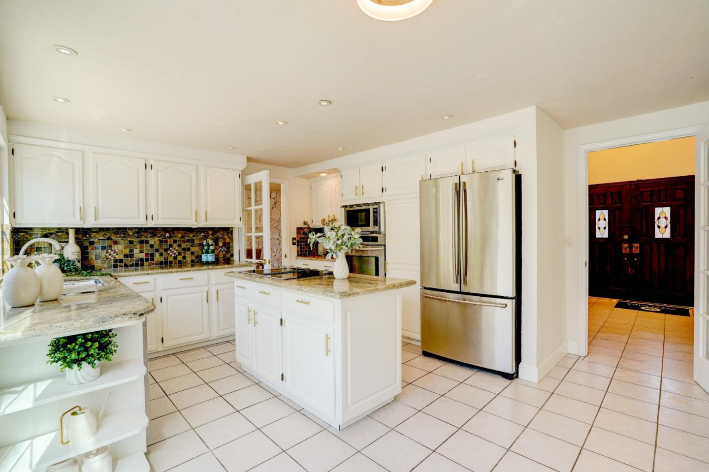 2945 Berryessa Road San Jose, CA 95132 - Photo 14 of 49 a kitchen with white cabinets a refrigerator and a stove top oven