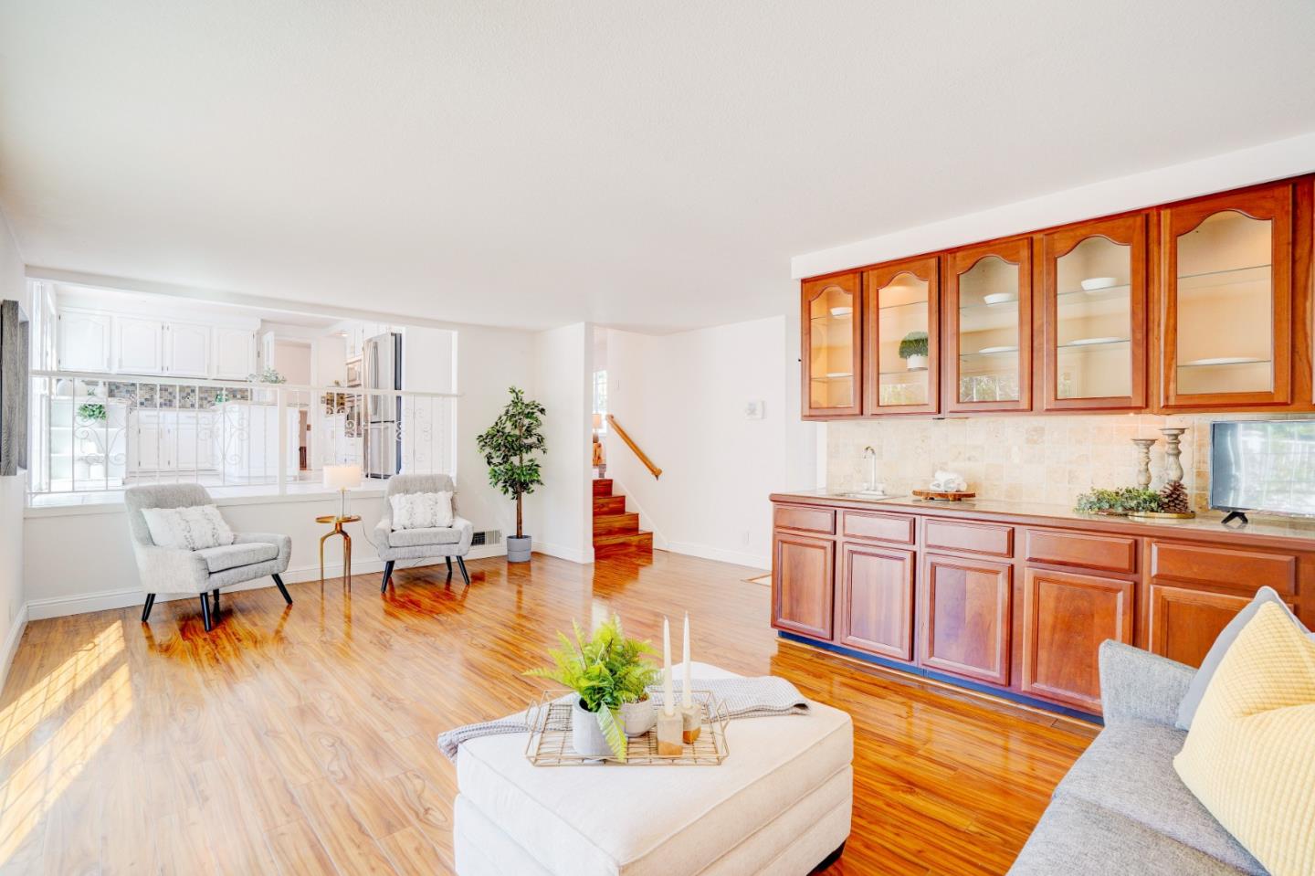 2945 Berryessa Road San Jose, CA 95132 - Photo 19 of 49 a living room with stainless steel appliances granite countertop a couch a dining table and chairs with wooden floor