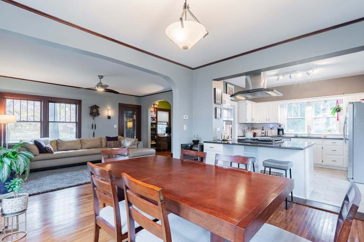 412 West Virginia Avenue Normal, IL 61761 - Photo 14 of 42 a large kitchen with kitchen island a stove a sink a dining table and chairs with wooden floor