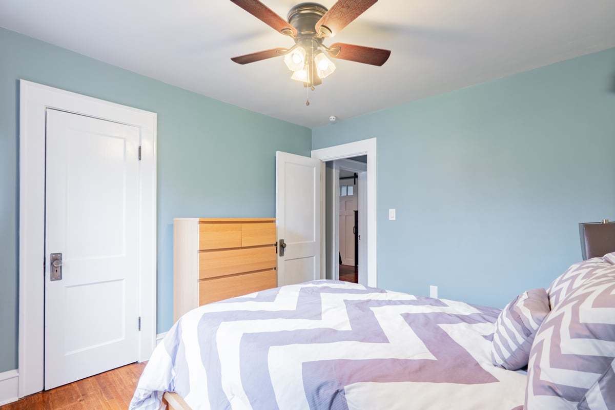 412 West Virginia Avenue Normal, IL 61761 - Photo 21 of 42 a bedroom with a bed and a chandelier