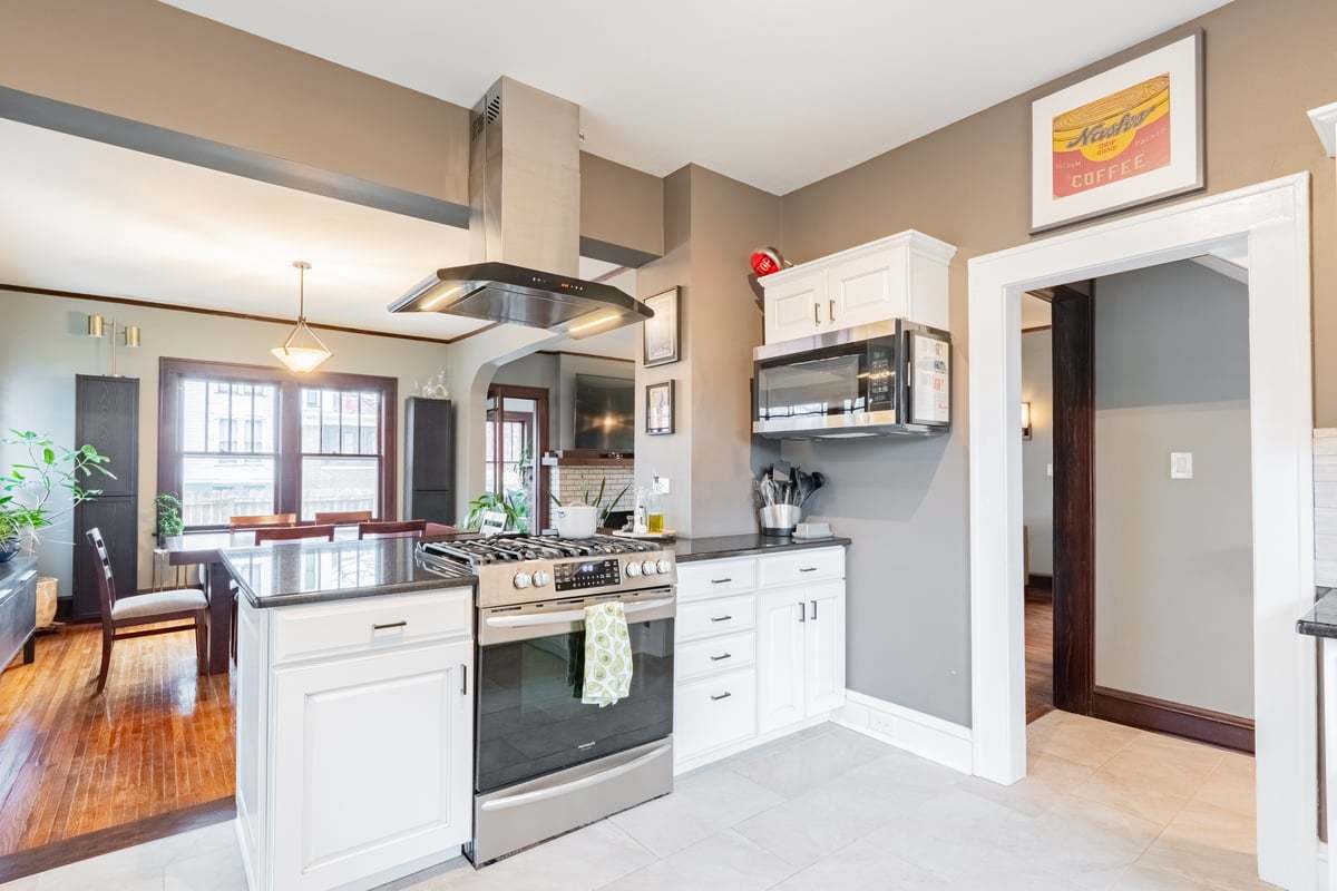 412 West Virginia Avenue Normal, IL 61761 - Photo 9 of 42 a kitchen with stainless steel appliances kitchen island granite countertop a stove and a sink