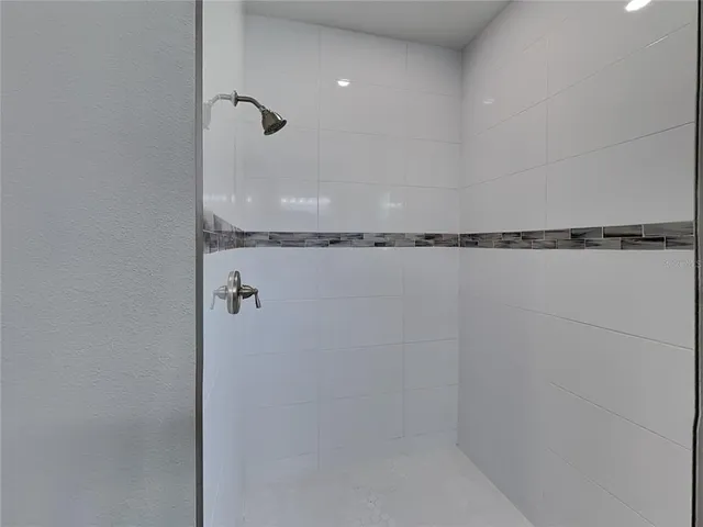 a bathroom with a shower and a shower