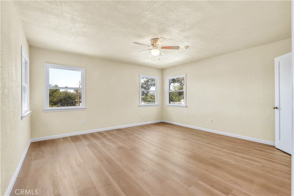 15905 Kugelman Street Lower Lake, CA 95457 - Photo 50 of 75 a view of an empty room with a window and wooden floor