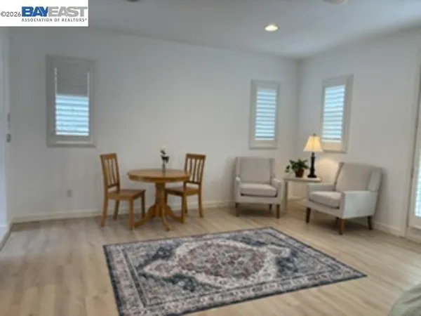 a living room with furniture rug and window