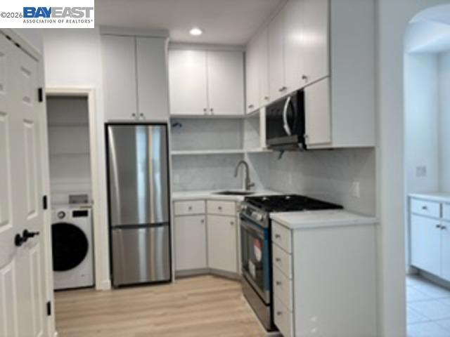 Undisclosed Address San Ramon, CA 94582 - Photo 4 of 15 a kitchen with stainless steel appliances a stove a refrigerator and cabinets