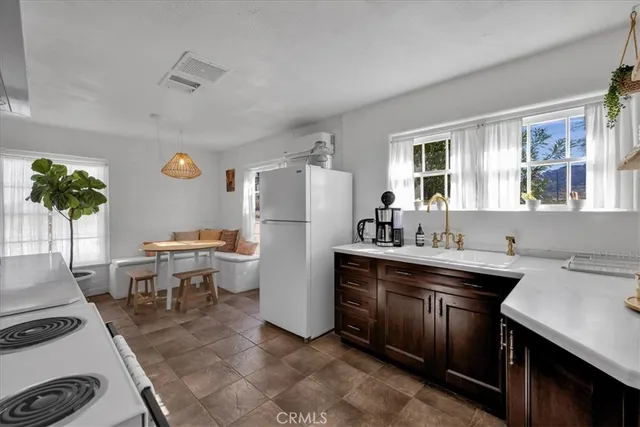 a kitchen with a sink and refrigerator