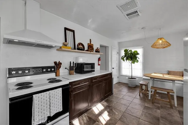 a kitchen with a sink a stove and cabinets