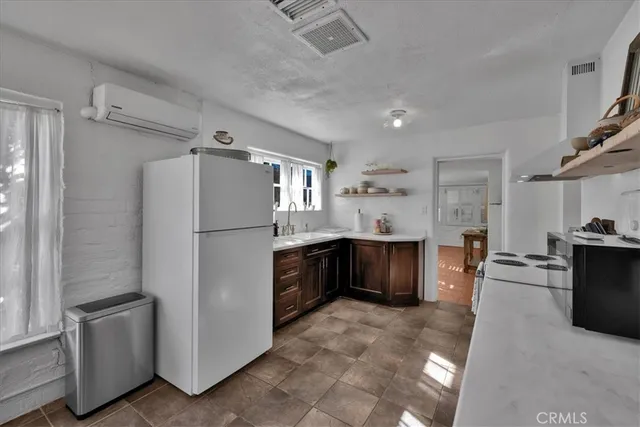 a kitchen with stainless steel appliances a refrigerator and a stove