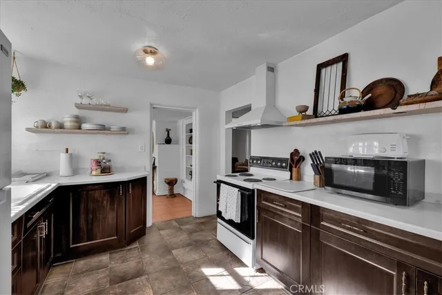 a kitchen with kitchen island a sink stainless steel appliances and cabinets