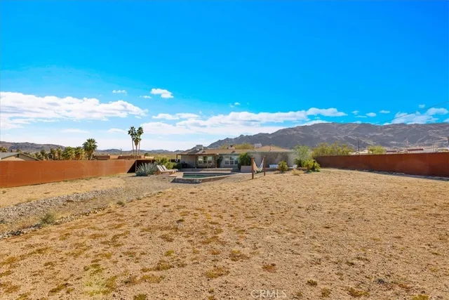 a view of a swimming pool with a patio and a garden