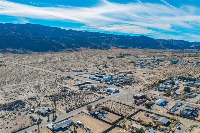 a view of a terrace with a table and chairs under an umbrella