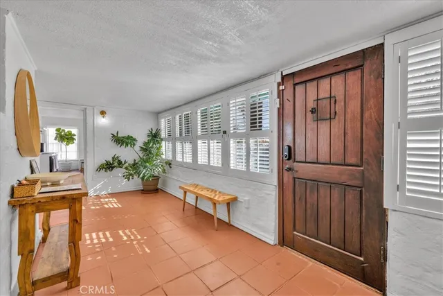 a view of a hallway with furniture and a window