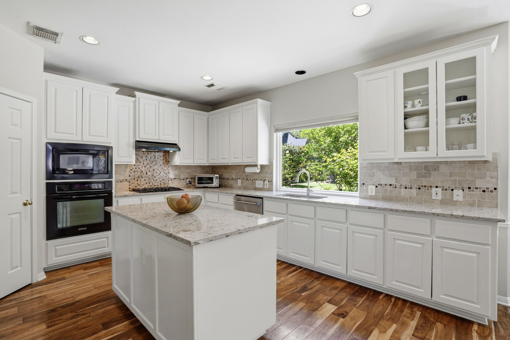 9113 Evening Primrose Path Austin, TX 78750 - Photo 9 of 34 a kitchen with stainless steel appliances granite countertop a stove a sink and a microwave