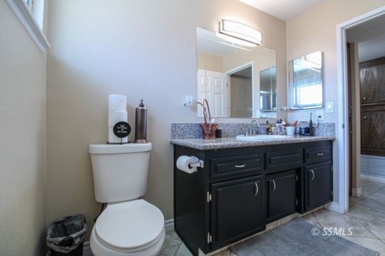 900 North Sierra View Street Ridgecrest, CA 93555 - Photo 22 of 42 a bathroom with a toilet sink and mirror