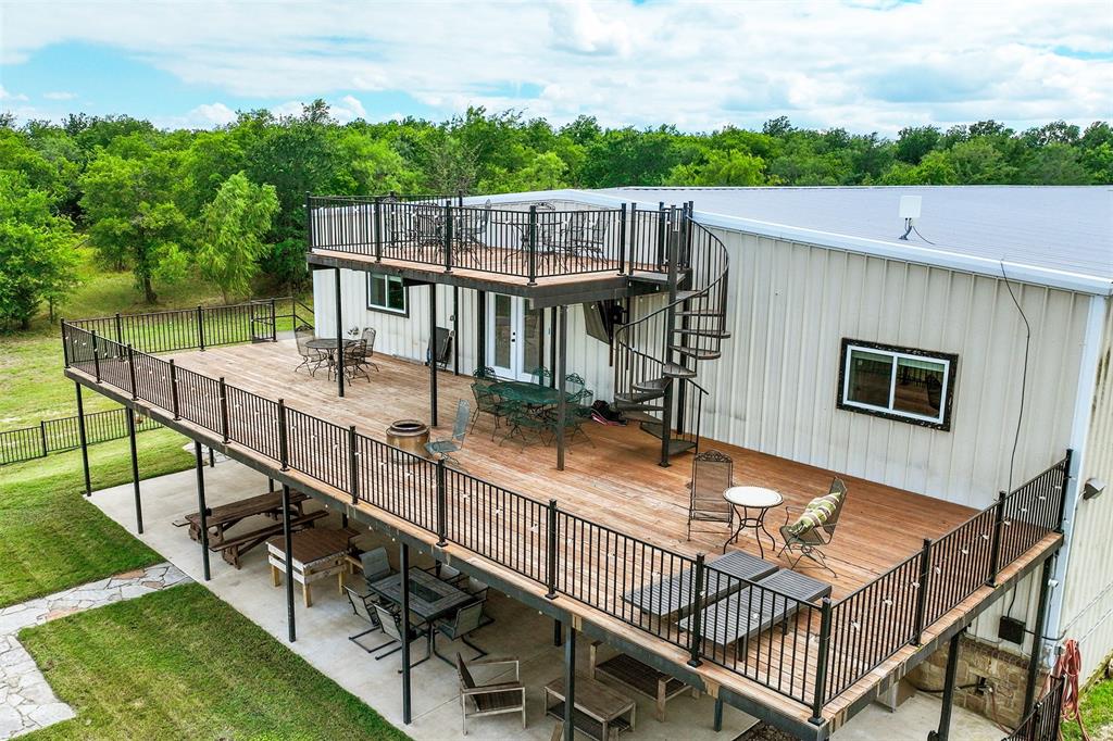 2129 Hcr 3322 Loop Hubbard, TX 76648 - Photo 4 of 38 Three stories of outdoor entertaining space, along with a fenced in yard and oversized built in firepit.