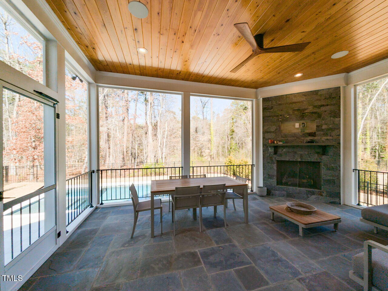 3416 Edgemont Drive Raleigh, NC 27612 - Photo 41 of 49 Screened Porch with gas log fire place and stone wall.