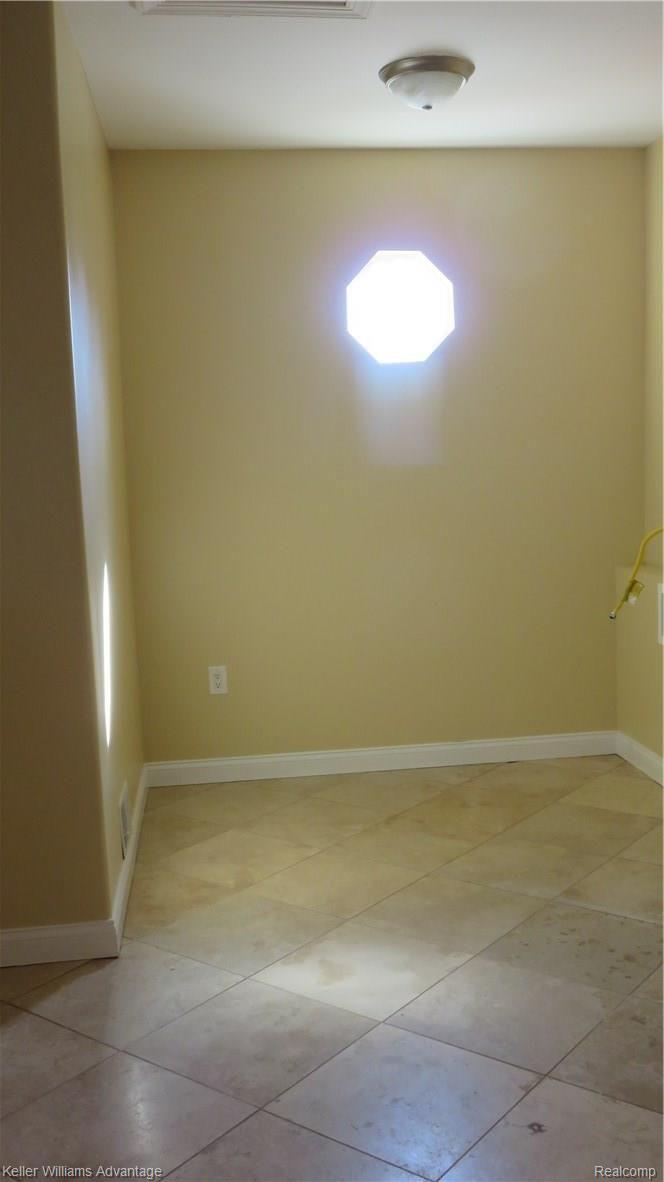 6487 North Beck Road Canton, MI 48187 - Photo 27 of 41 Master hook closet with stone floors and second laundry hook ups