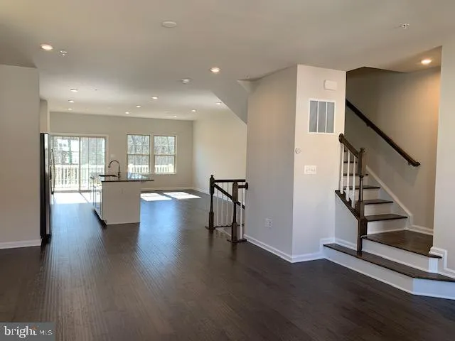 a view of a room with wooden floor and stairs