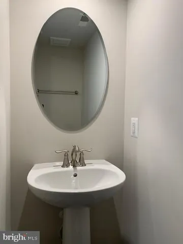 a bathroom with a sink a mirror and vanity