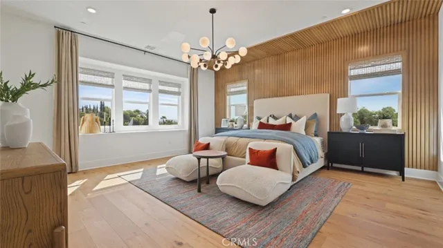 a bedroom with furniture and a large window