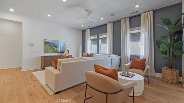 a living room with furniture and a potted plant