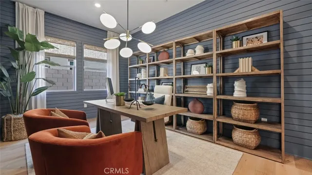 a view of a livingroom with furniture and a bookshelf