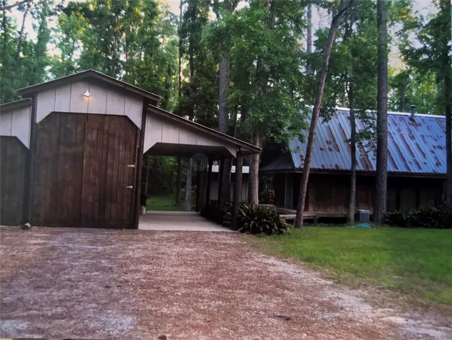 a front view of house with yard and trees