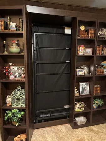 a living room with storage and a table
