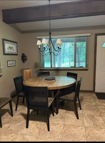 a view of a dining room with furniture window and outside view