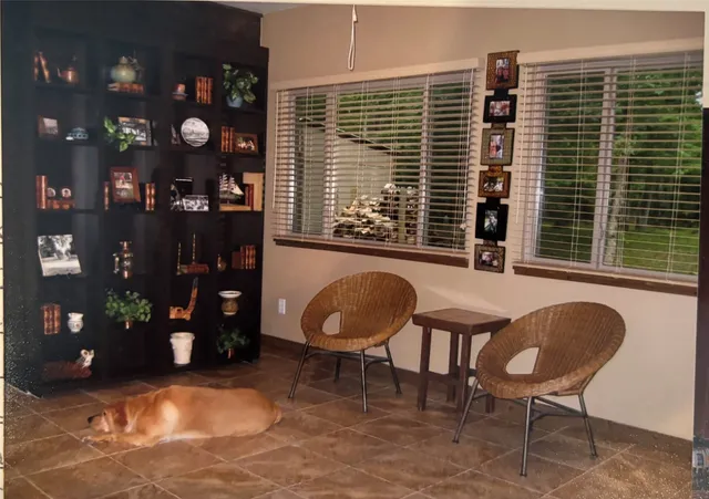 a view of a room with furniture and a window