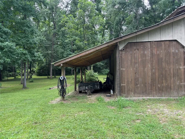 a backyard of a house with swing and plants