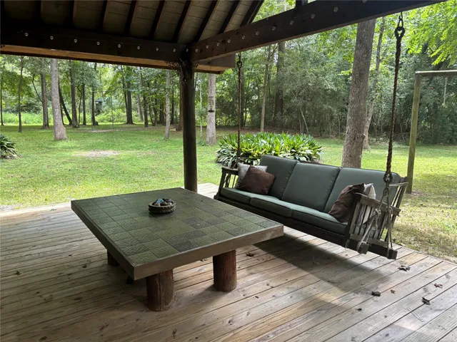 a view of a couches in patio with a yard