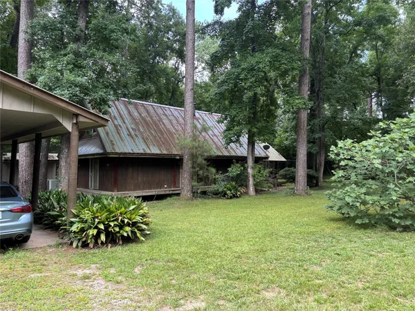 a view of a house with garden and sitting area
