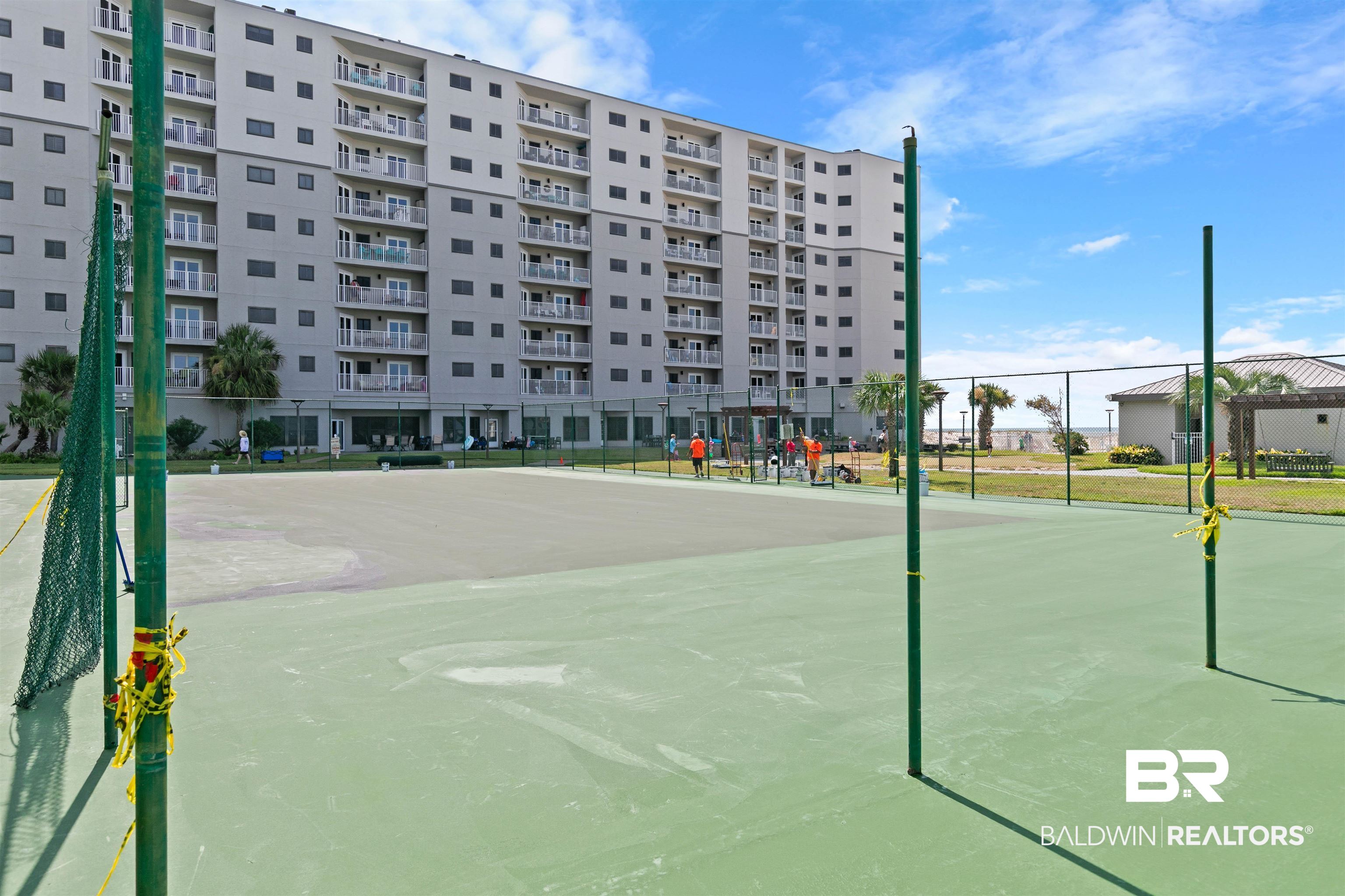 645 Plantation Road, Unit 6606 Gulf Shores, AL 36542 - Photo 60 of 60 On-site tennis courts with a multi-story building backdrop