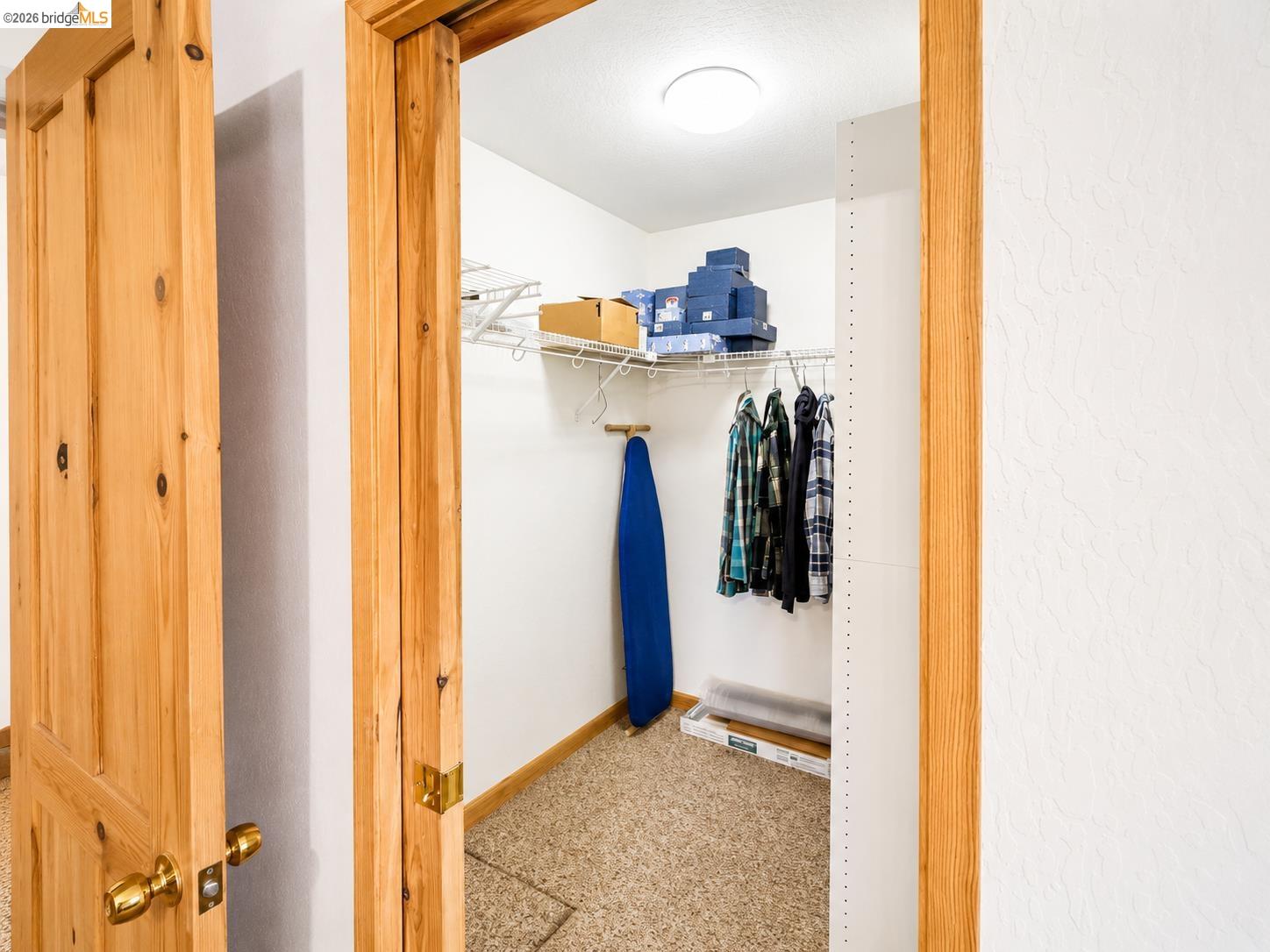 21181 Phoenix Lake Road Sonora, CA 95370 - Photo 26 of 34 Walk-in closet featuring wire shelving, hanging rods, and light wood trim