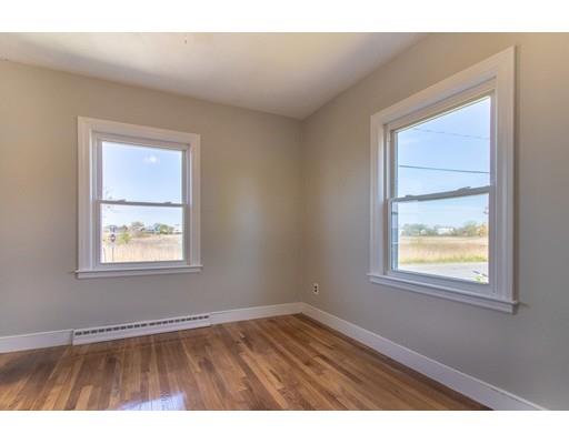 161 Nantasket Road Hull, MA 02045 - Photo 13 of 26 a view of an empty room with wooden floor and a window