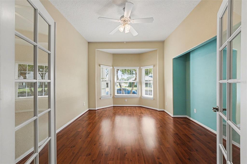 122 Costa Loop Auburndale, FL 33823 - Photo 13 of 30 wooden floor in an empty room with a window