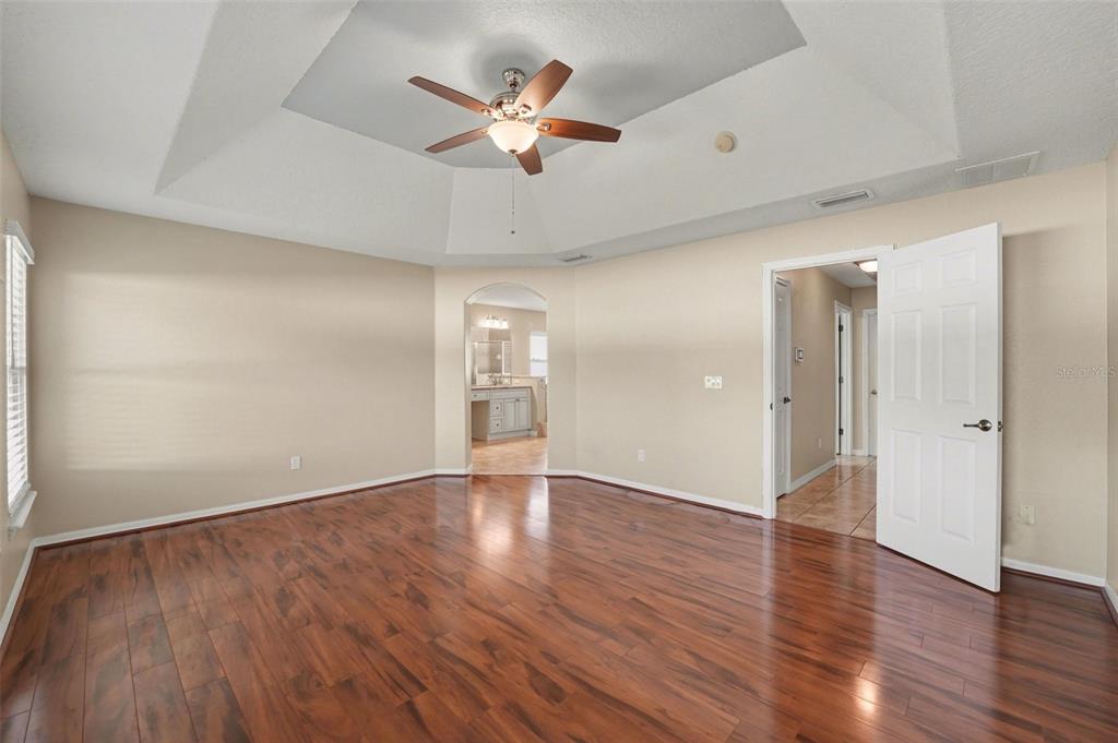 122 Costa Loop Auburndale, FL 33823 - Photo 15 of 30 an empty room with wooden floor and ceiling fan