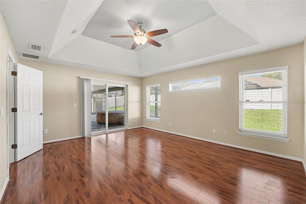 122 Costa Loop Auburndale, FL 33823 - Photo 17 of 30 a view of an empty room with wooden floor and a window