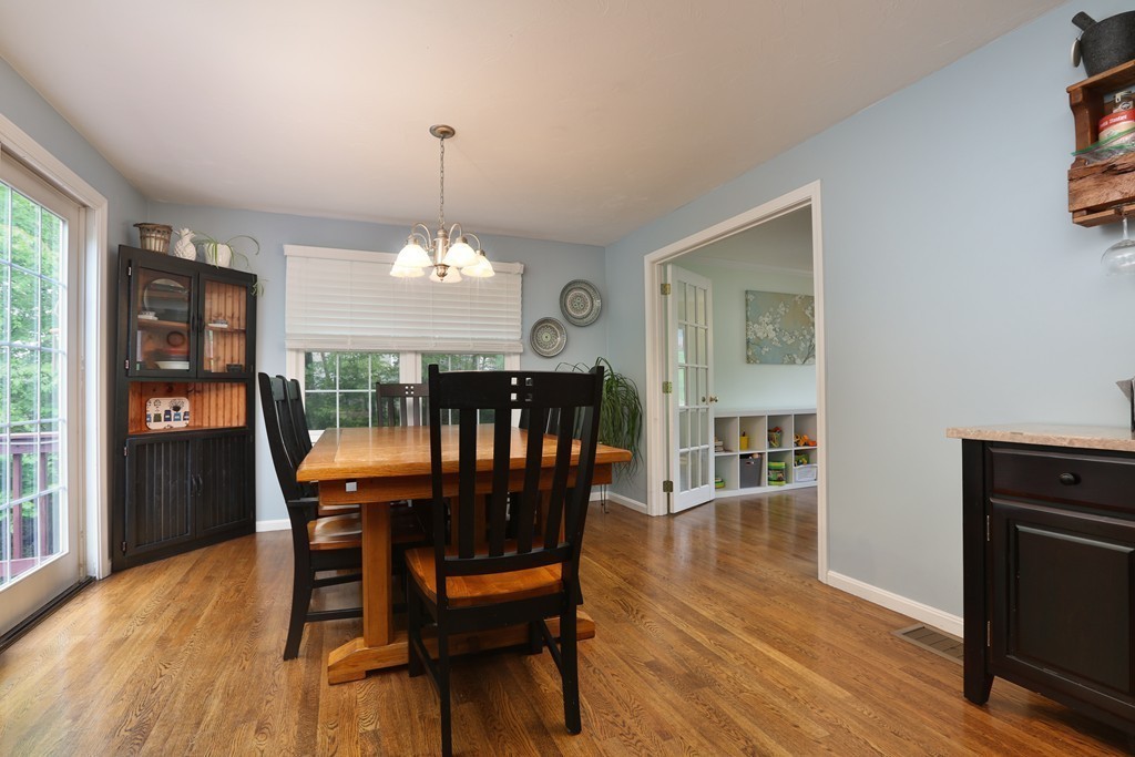 139 Morgan Road Northbridge, MA 01588 - Photo 5 of 22 a dining room with furniture a chandelier and wooden floor