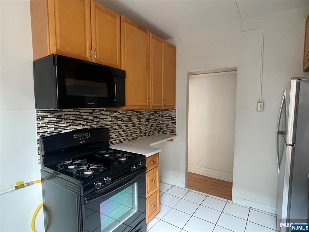 a kitchen with granite countertop a stove and a refrigerator