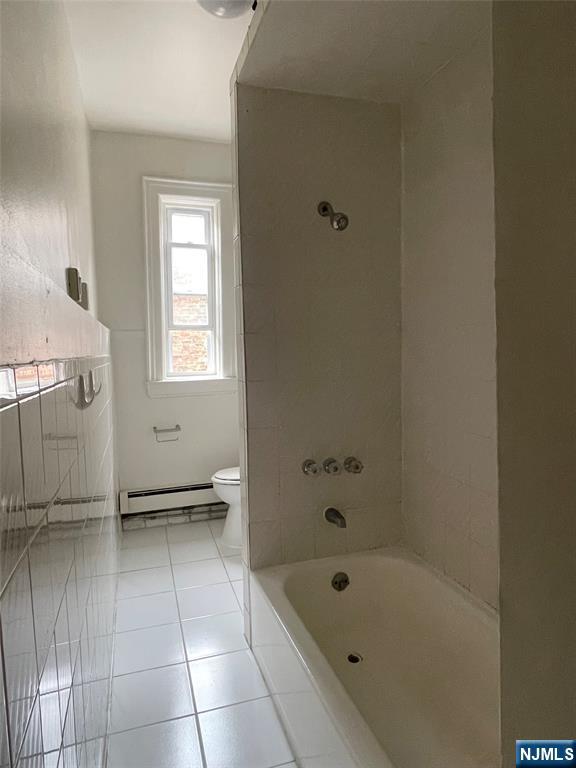 10 Hilliard Avenue, Unit 5 Edgewater, NJ 07020 - Photo 8 of 12 a bathroom with a tub shower and vanity