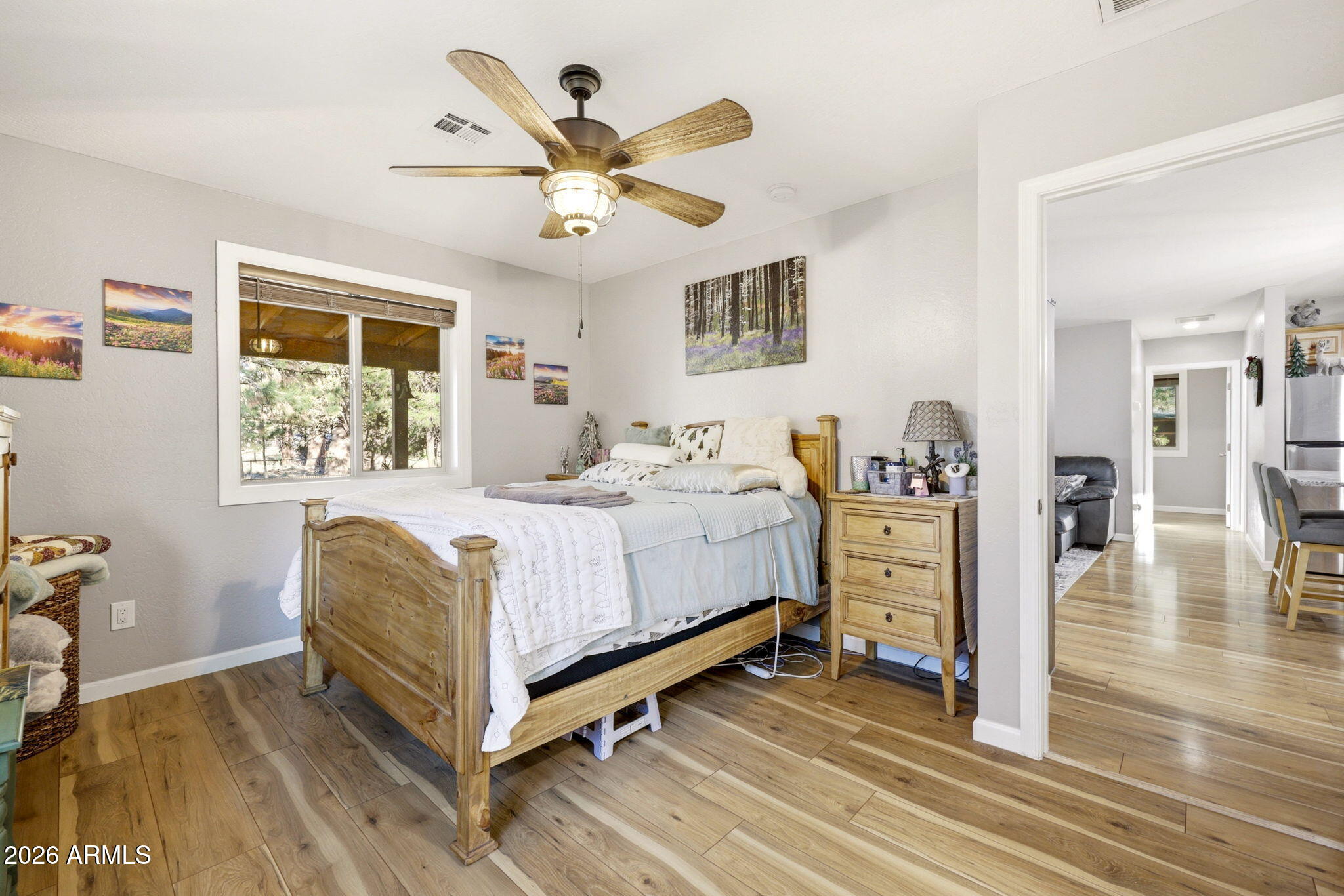 2900 Long Rifle Place Overgaard, AZ 85933 - Photo 12 of 35 a bedroom with a large bed a chandelier and a window