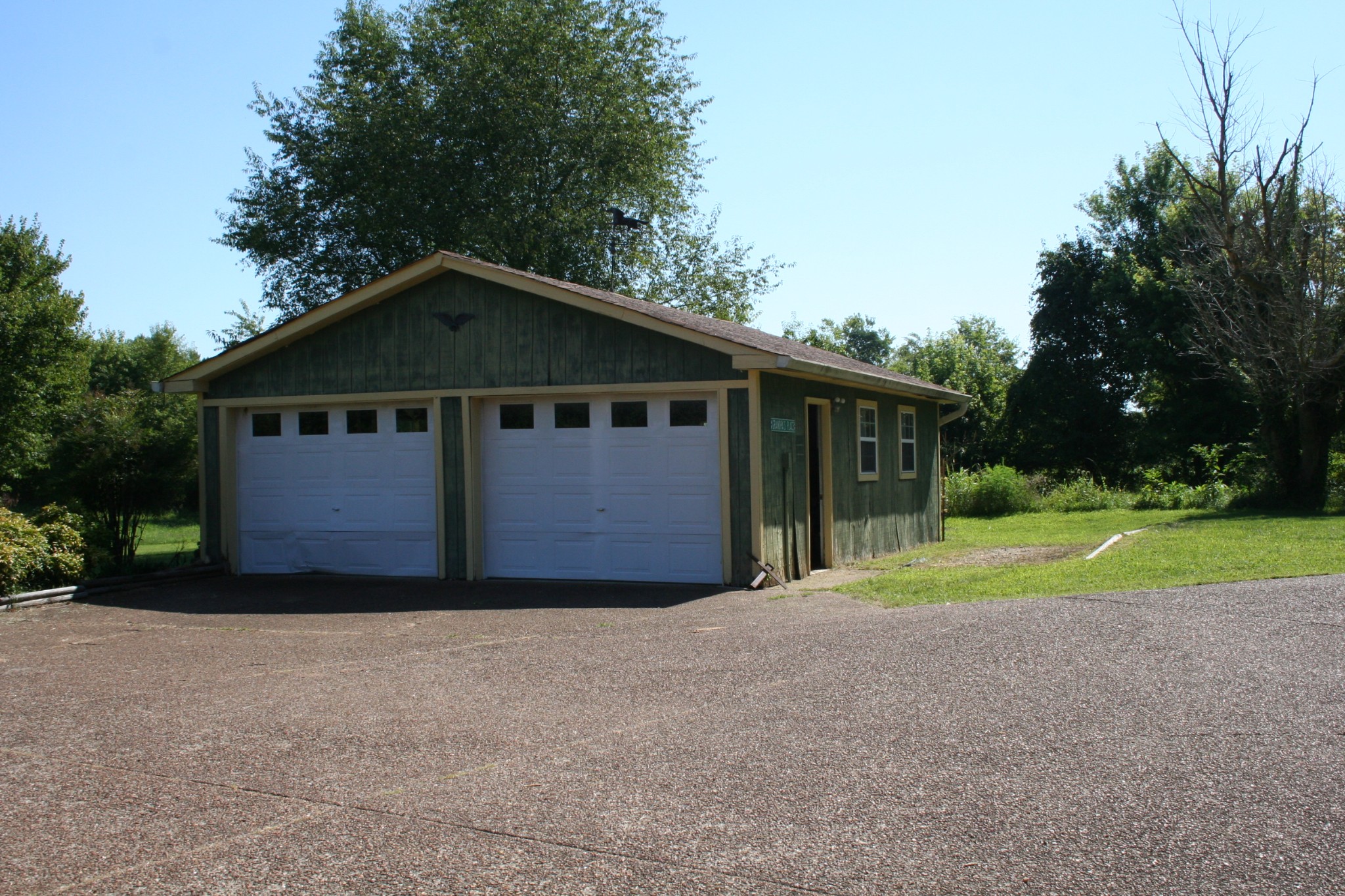 7080 Swift Road Greenbrier, TN 37073 - Photo 42 of 47 a front view of a house with a yard and garage