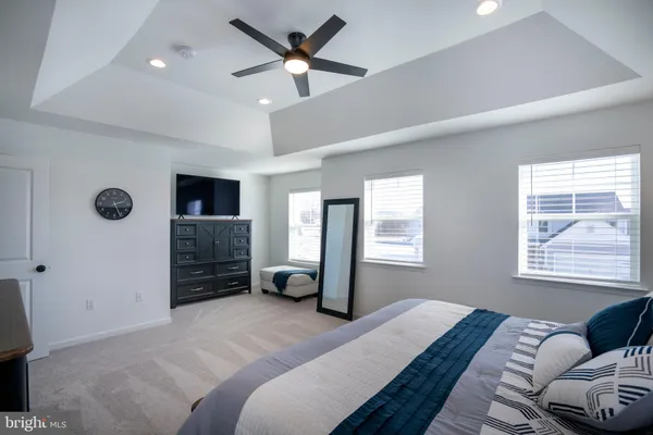 a bedroom with a bed and a television