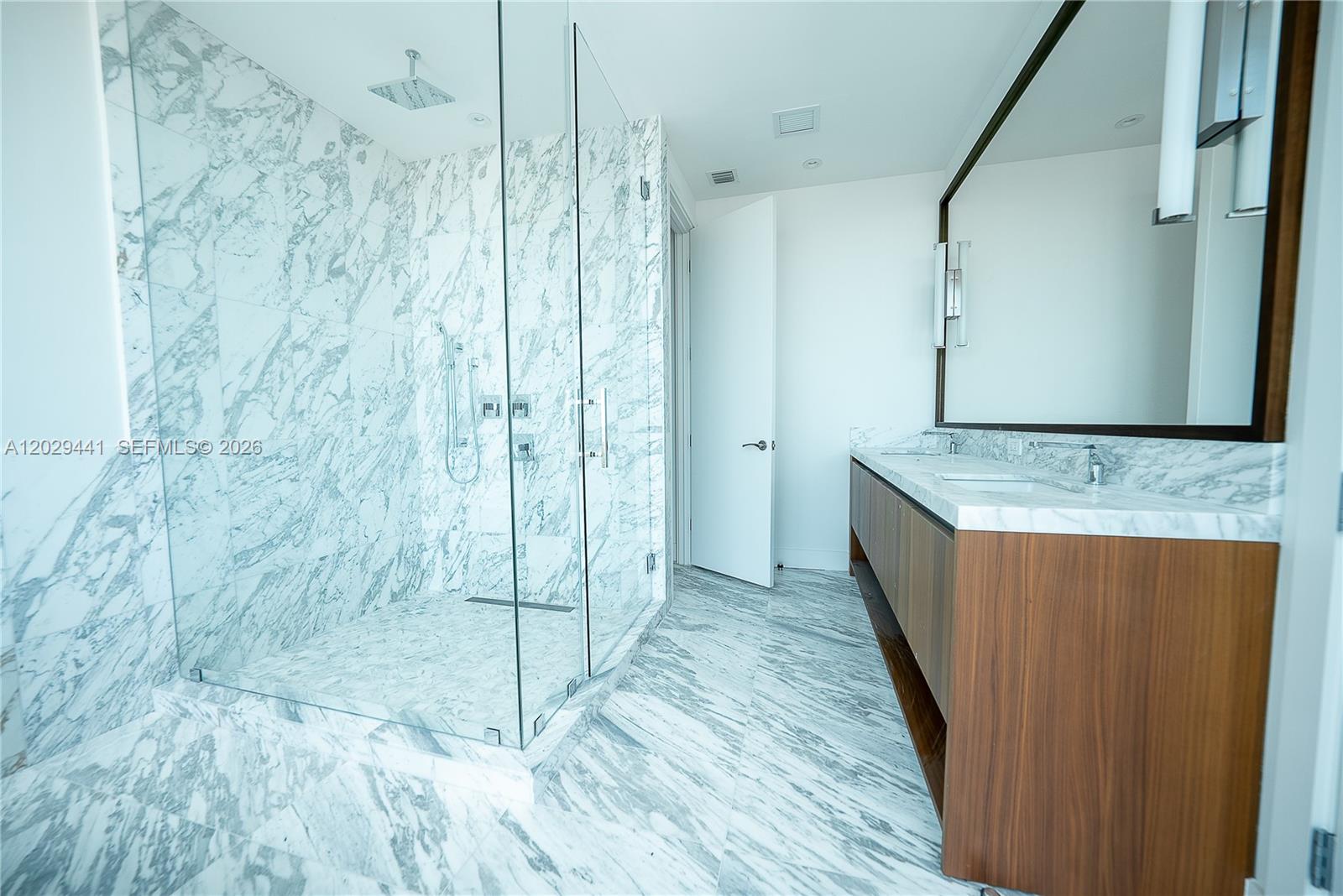 175 Southeast 25th Road, Unit 2103 Miami, FL 33129 - Photo 18 of 27 a bathroom with a granite countertop sink a mirror and shower