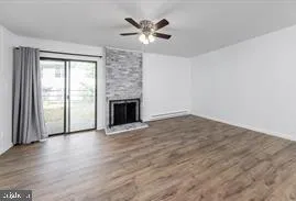 wooden floor in an empty room with a fireplace