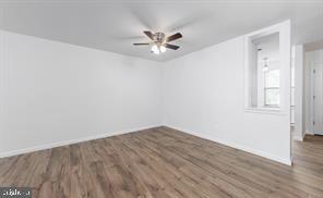 503 Bromley Estate Pine Hill, NJ 08021 - Photo 3 of 9 an empty room with wooden floor and windows